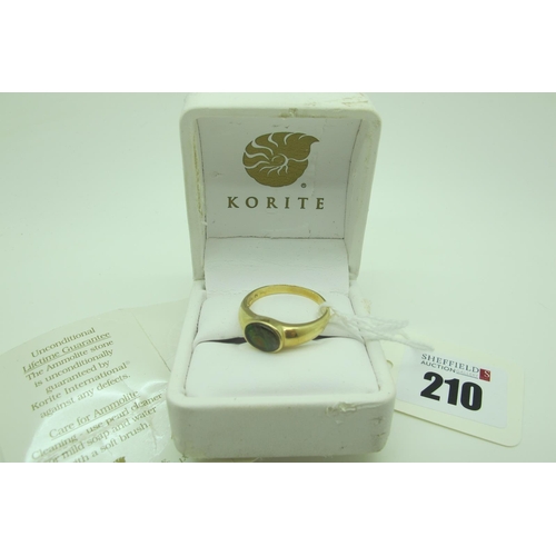 210 - Korite; A Modern Canadian Ammolite Single Stone Ring, oval collet set, stamped 