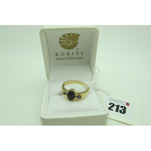 213 - Korite; A Modern 14ct Gold Canadian Three Stone Ring, oval and circular collet rubover set, also sta... 