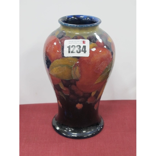 1234 - A Moorcroft Pottery Vase, of baluster form, painted in the Pomegranate pattern against a dark blue g... 