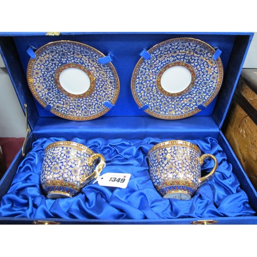 1349 - Pipatana Benjarong, pair of cups and saucers, hand painted, allover floral and gilt, in case.