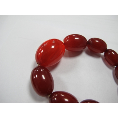 304 - A Cherry Amber Coloured Single Strand Graduated Bead Necklace, together with a vintage mother of pea... 