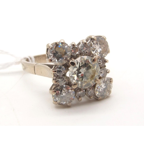 105 - A Large Diamond Cluster Cocktail Ring, of square design, claw set throughout with brilliant cut diam... 