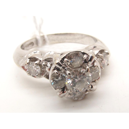 111 - A Modern Diamond Cluster Ring, claw set with brilliant cut stones, high between brilliant cut diamon... 