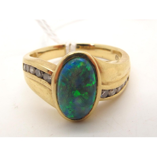 112 - An Australian Black Opal and Diamond Set Dress Ring, oval cabochon collet set to the centre, between... 