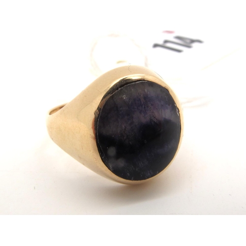 114 - A 9ct Gold Blue John Oval Signet Style Ring, oval cabochon rubover set to the centre (closed back se... 