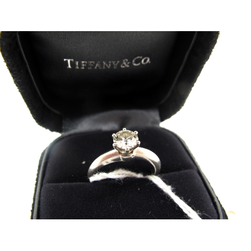 117 - Tiffany & Co; A Modern Platinum Single Stone Diamond Ring, the brilliant cut stone claw set between ... 