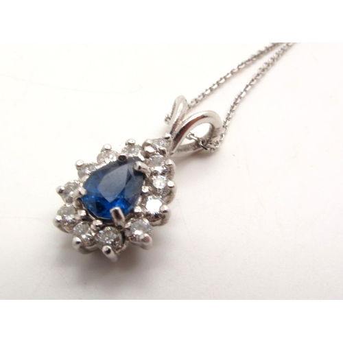 75 - An 18ct White Gold Diamond Set Teardrop Cluster Pendant, claw set throughout, on a fine chain stampe... 