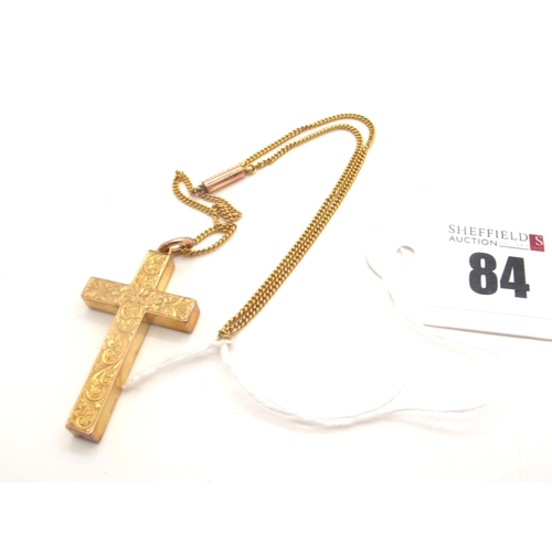 84 - A 9ct Gold Cross Pendant, leaf scroll engraved, suspended on a short chain.