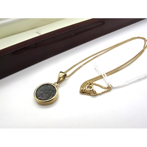 84A - A Modern 9ct Gold Gems TV Widow's Mite Pendant, collet set, on a fine chain.