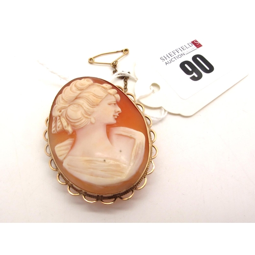 90 - A 9ct Gold Oval Shell Carved Cameo Brooch, depicting female profile, collet set within openwork sett... 