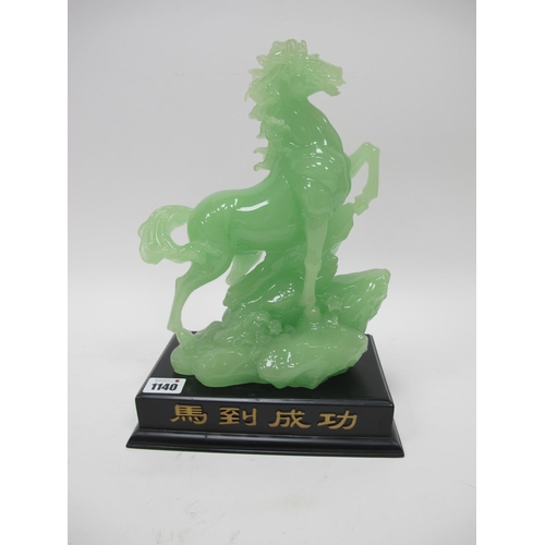 1140 - A Chinese Green Hardstone Model of a Prancing Horse Standing on Rocks, upon a black stepped rectangu... 