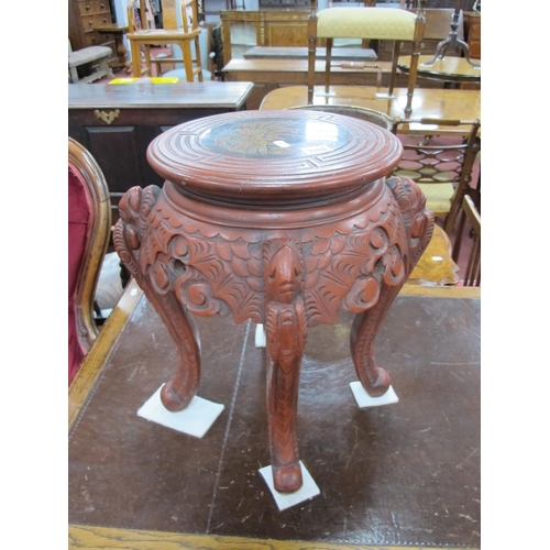 1148 - An Early XX Century Chinese Red Lacquer Stand, the circular top decorated with a phoenix within a ke... 