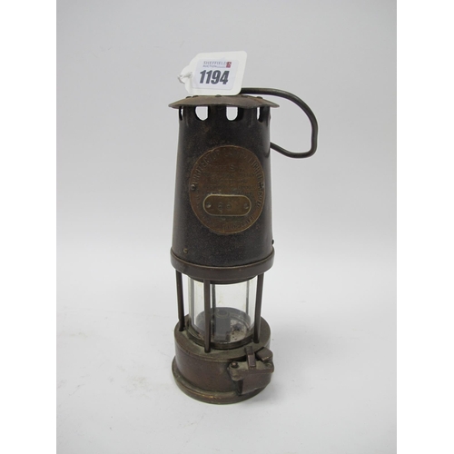 1194 - Miners Lamp, The Protector, Eccles, type SL '65' to applied plaque, 24cm high with handle down.