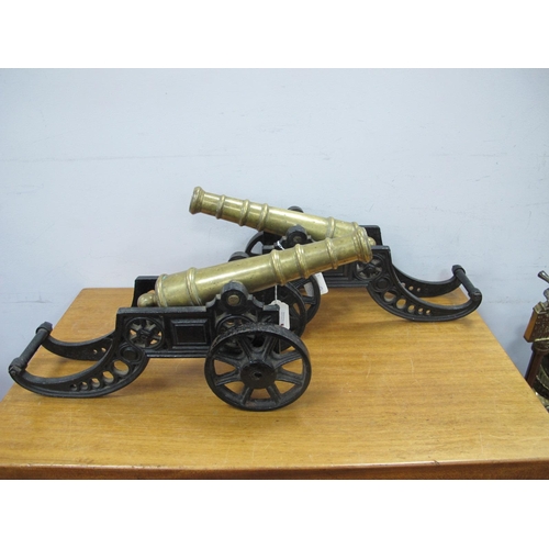 1233 - A Pair of Early XX Century Brass Model Cannon, with stepped barrels on cast iron wheeled bases, 41cm... 