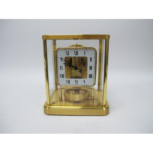 1462 - A Jaeger-Le-Coultre Atmos Clock, in brass case, the square dial with black Roman numerals on white g... 