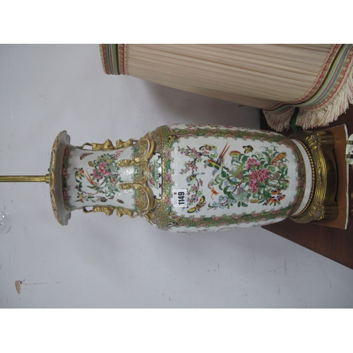 1149 - A Chinese Canton Famille Rose Vase, converted to a table lamp with shade, the panels profusely decor... 