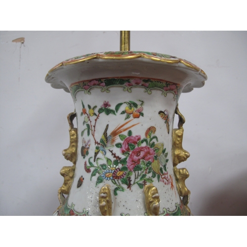 1149 - A Chinese Canton Famille Rose Vase, converted to a table lamp with shade, the panels profusely decor... 