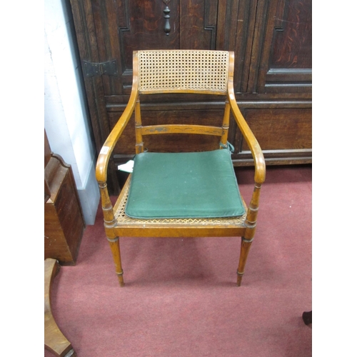 1653 - A XIX Century Painted Bergére Armchair, with caned back and seat, shaped arms, on turned legs.