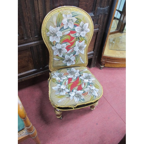 1654 - A XIX Century Gilded Nursing Chair, back and seat with beadwork floral decoration, on turned and ree... 