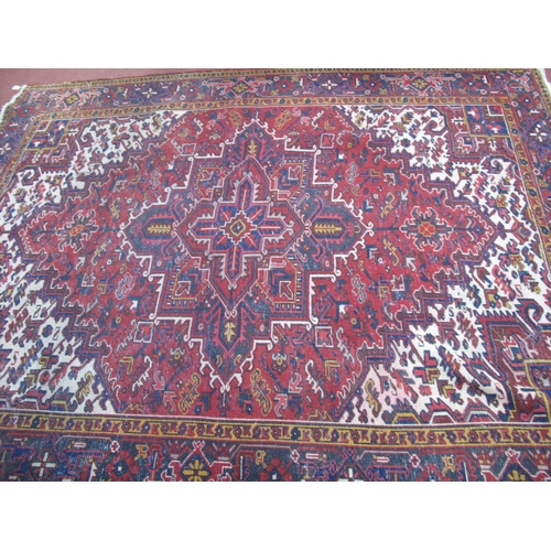 1630 - A XX Century Persian Style Wool Carpet, border with floral and lozenge decoration, red ground centra... 