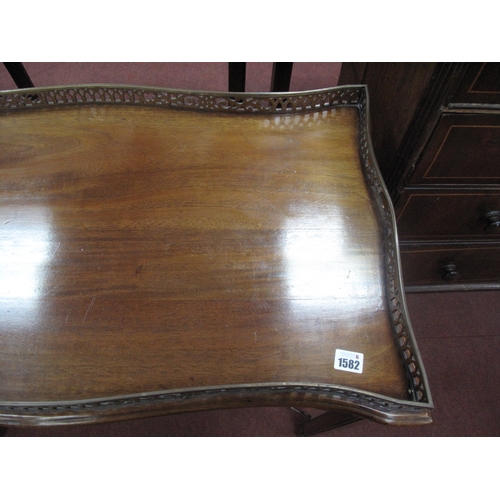 1582 - A Chippendale Style Mahogany Silver Table, with a pierced gallery on square supports, united by pier... 