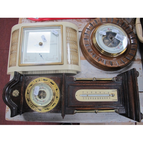 1091 - An Early XX Century Circular Aneroid Barometer, bakelite  table top barometer; together with a barom... 