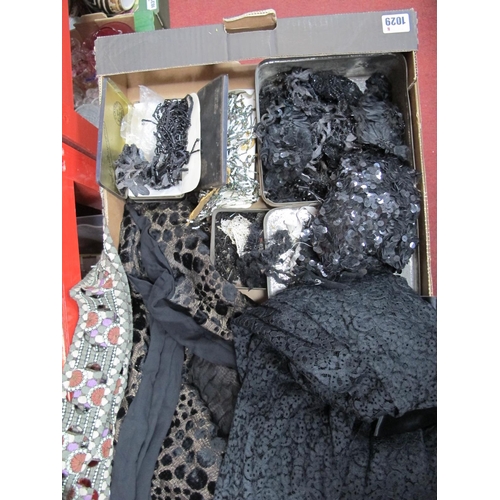 1029 - A Mid XX Century Black Jackets, black bead work costume decorations, tins, etc:- One Box.