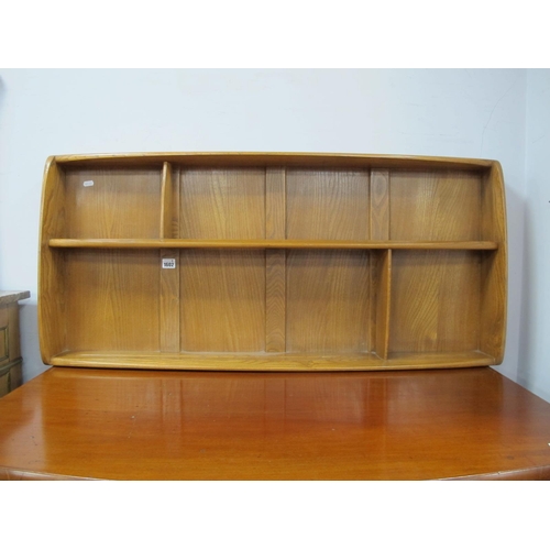 1602 - Ercol Elm Wall Hanging Rack, with a single shelf, 107cm wide.