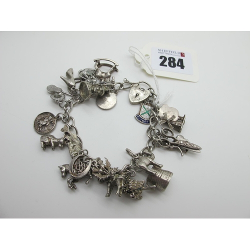 284 - A Curb Link Charm Bracelet, to a heart shape padlock style clasp (stamped 