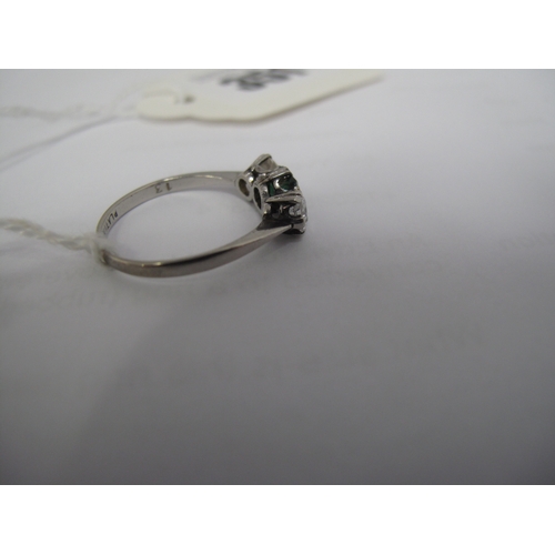 351 - A Three Stone Dress Ring, alternately claw set between tapered shoulders, stamped 