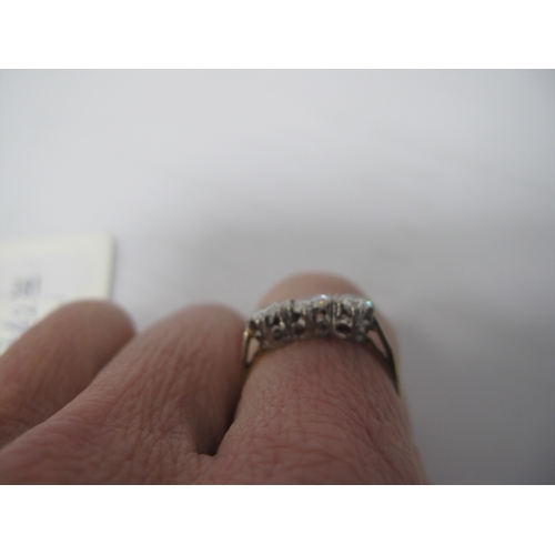 381 - A Three Stone Diamond Ring, claw set throughout, between plain shoulders, stamped 