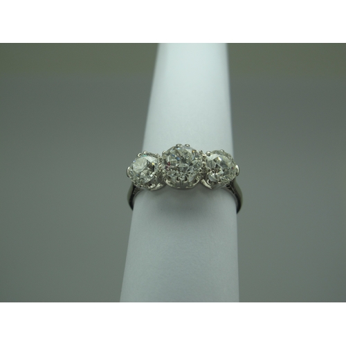 187 - A Large Three Stone Diamond Ring, the graduated old cut stones claw set, stamped 