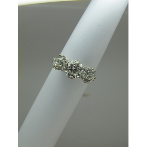 187 - A Large Three Stone Diamond Ring, the graduated old cut stones claw set, stamped 