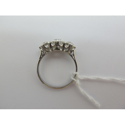 187 - A Large Three Stone Diamond Ring, the graduated old cut stones claw set, stamped 