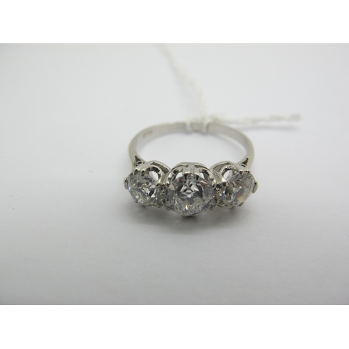 187 - A Large Three Stone Diamond Ring, the graduated old cut stones claw set, stamped 