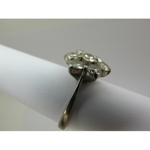 214 - An 18ct White Gold Seven Stone Diamond Flowerhead Cluster Ring, claw set throughout with brilliant c... 