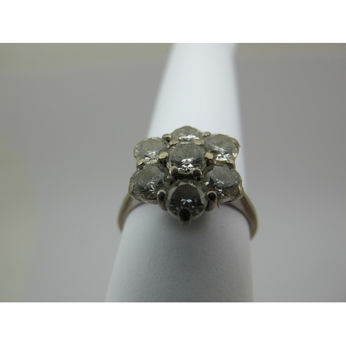 214 - An 18ct White Gold Seven Stone Diamond Flowerhead Cluster Ring, claw set throughout with brilliant c... 