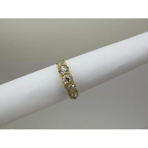 221 - An Edwardian 18ct Gold Five Stone Diamond Ring, the graduated old cut stones within scroll carved se... 