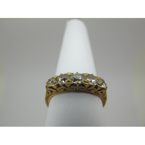 221 - An Edwardian 18ct Gold Five Stone Diamond Ring, the graduated old cut stones within scroll carved se... 