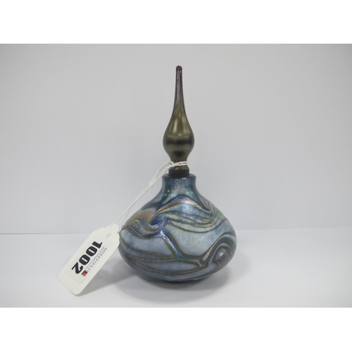 1002 - An Okra Glass Scent Bottle and Stopper, designed by Richard P. Golding, with a scrolling design agai... 