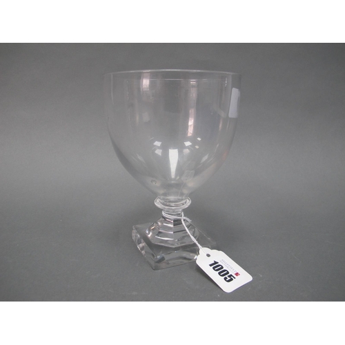 1005 - A Late XVIII/Early XIX Century Glass Goblet, the pear shaped bowl raised on a faceted stem and squar... 