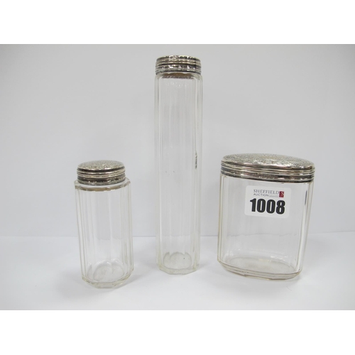 1008 - Two Late XIX Century Fluted Clear Glass Dressing Table Jars and an Oval Example, each with cylindric... 