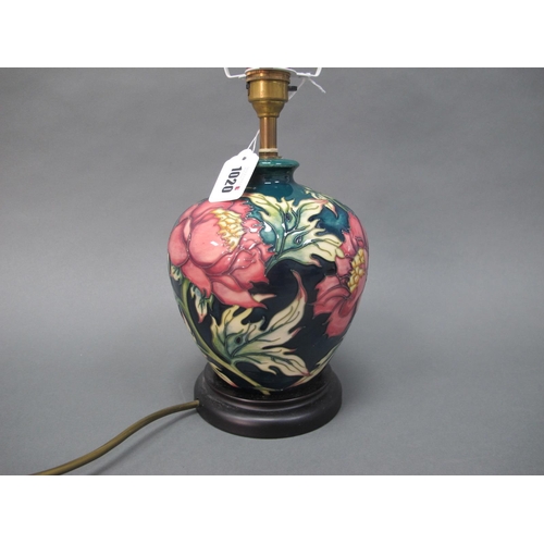 1020 - A Moorcroft Pottery Table Lamp, painted in the 'Peony' pattern against a dark blue ground, mounted o... 