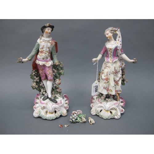 1052 - A Pair of XVIII Century Porcelain Figures of a Lady and Gentleman, each standing before a bocage flo... 