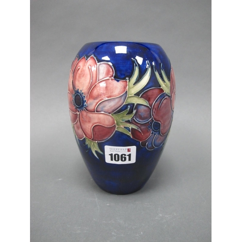 1061 - A Moorcroft Pottery Vase, of ovoid form, painted in the Anemone pattern with pink and purple flowers... 