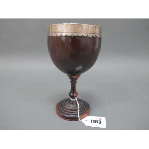 1163 - An Early XIX Century Coconut Goblet, with white metal collar, raised on a stepped circular base, 18c... 