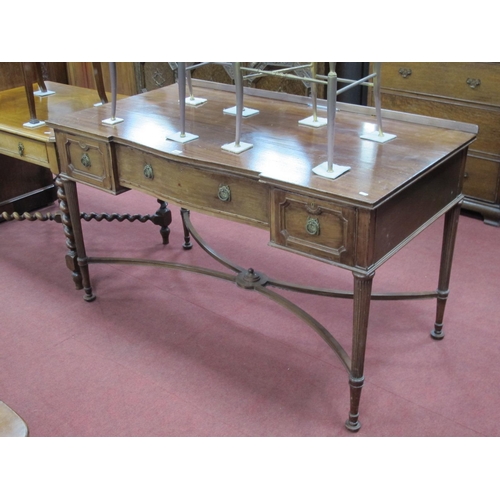 1449 - A XX Century Mahogany Side Table, with low back and central drawer, flanking drawers, on turned and ... 