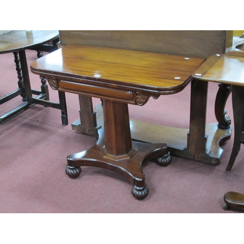 1458 - A XIX Century Mahogany Tea Table, with fold-over top, raised on an octagonal pedestal with shaped ba... 