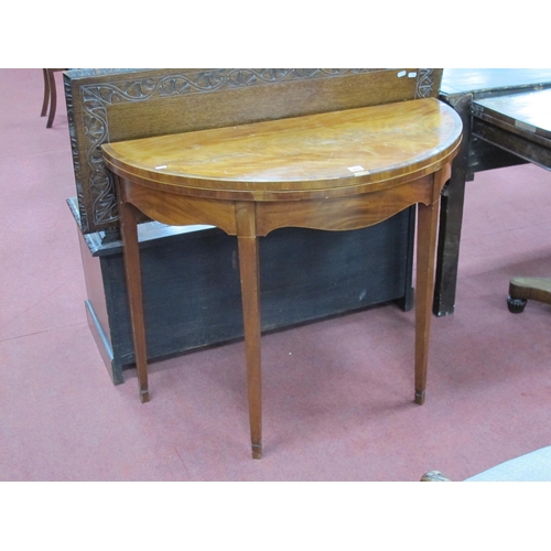 1477 - A Late XVIII Century Mahogany Demi Lune Card Table, with crossbanded top and baized interior, on tap... 