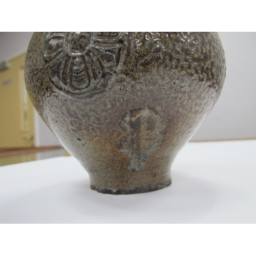 1038 - A German Salt Glazed Bellarmine Jug, moulded with stylised floral roundel and mask face to the neck,... 